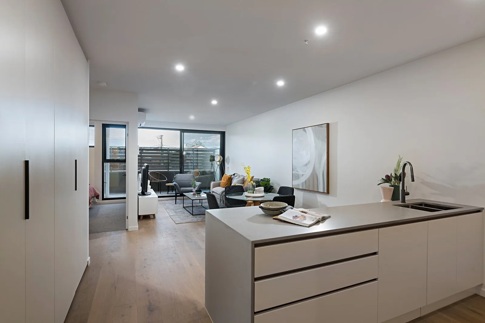 The Elm, Moonee Ponds: open-plan kitchen and hallway with timber flooring