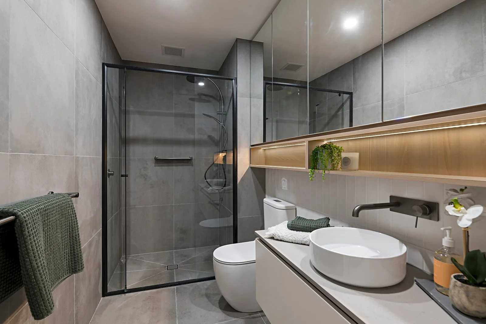 The Elm, Moonee Ponds: apartment bathroom with floating vanity and black-framed shower