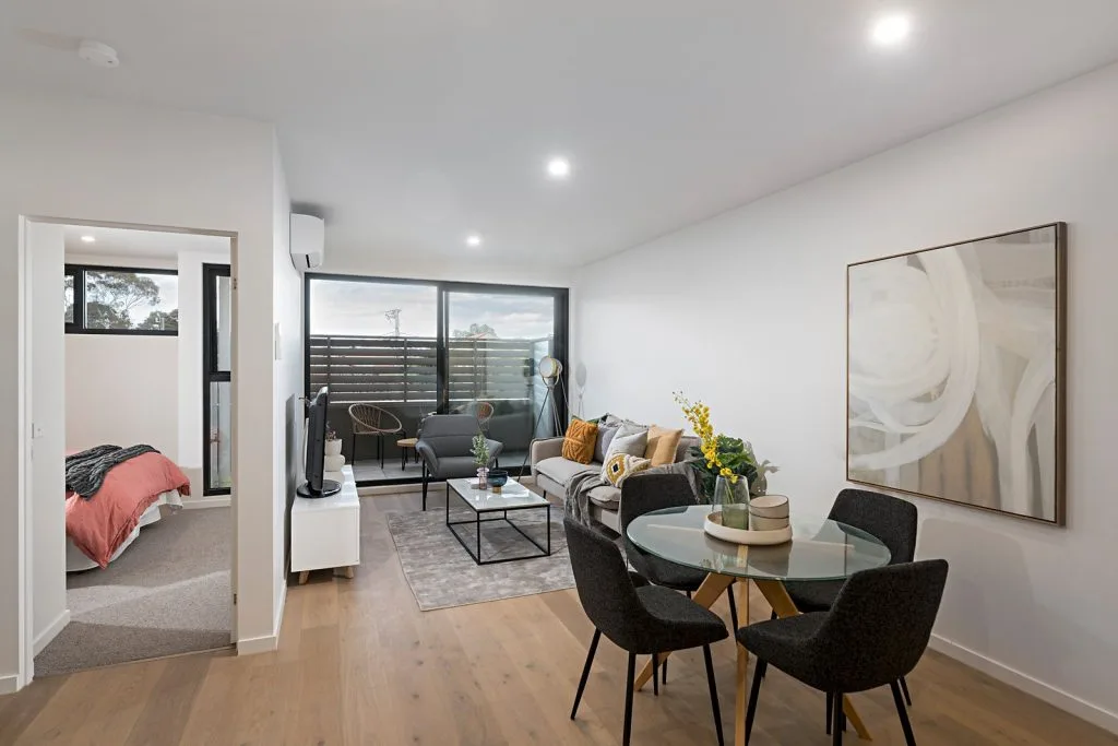 The Elm, Moonee Ponds: living and dining area with bedroom beyond