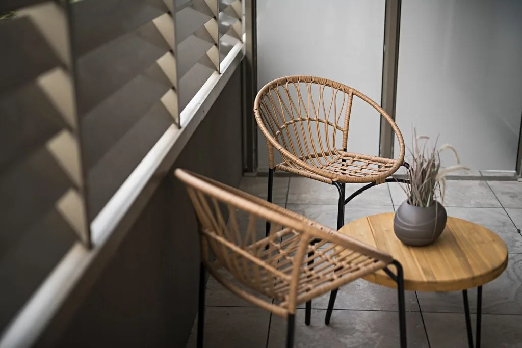 The Elm, Moonee Ponds: private balcony with louvres and rattan chairs