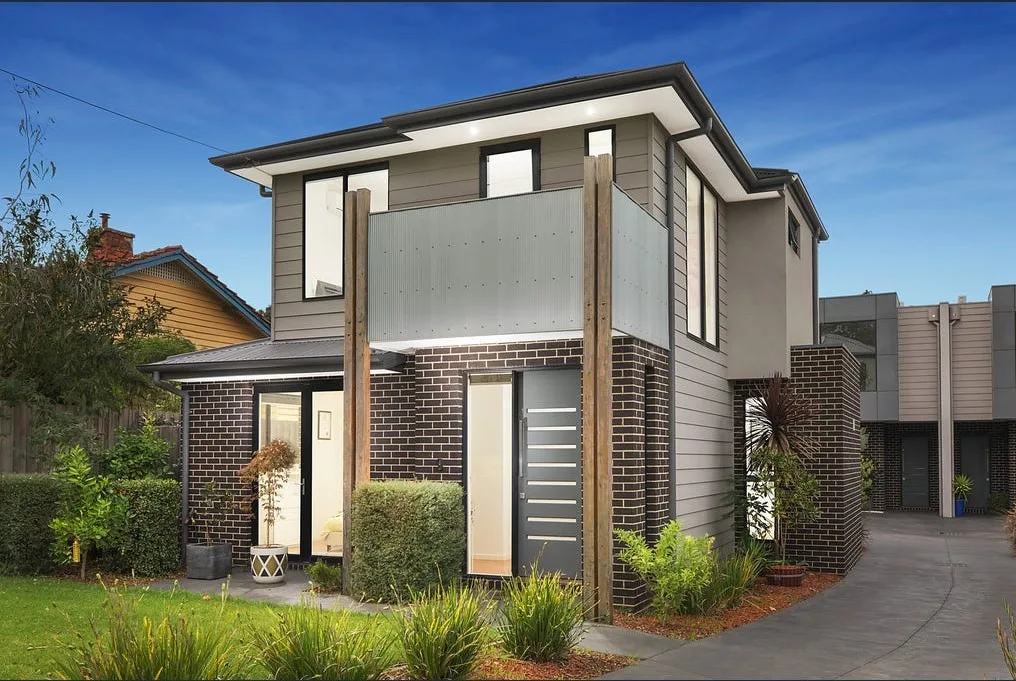 Edwin townhouses, Heidelberg Heights: dark brick facade with timber detailing